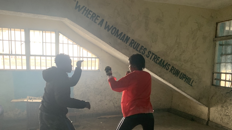 Two women boxing.