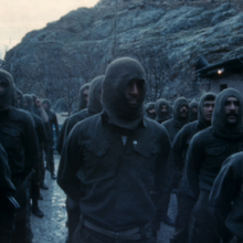 Rows of men standing in the same outfits.