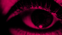 Close up of a human eye and eyelashes stylised with a digitised appearance in duotone colours of red and black