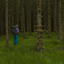 A hiker wearing a backpack is standing on green grassy ground surrounded by trees