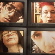 An image of four CRT TV screens, with varying faces on
