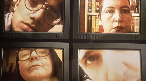 An image of four CRT TV screens, with varying faces on