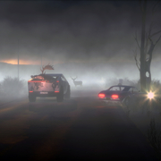 A dark, foggy, and misty night with a few cards and a stop sign.