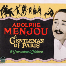 Vintage movie poster for "A Gentleman of Paris," featuring Adolphe Menjou's name prominently and artistic silhouettes of dancers and social scenes.
