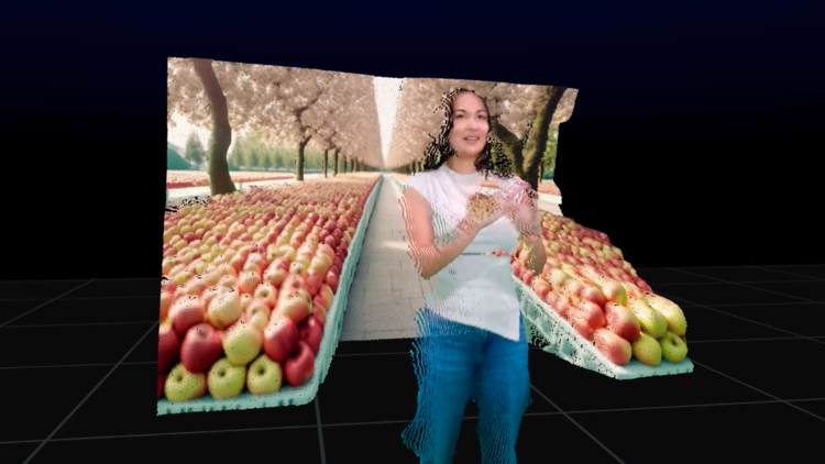 An image of a woman wearing a white t shirt and blue jeans, rendered in a 3D environment, surrounded by two separate shelves of apples, with an apple orchard in the background. She is smiling, looking off camera to the right. 