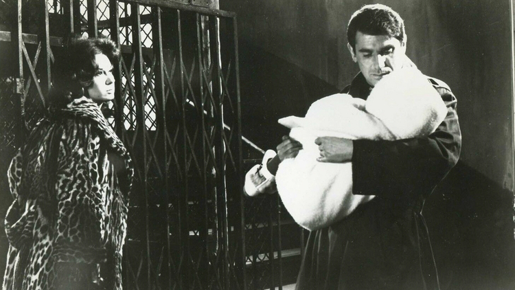 A still from the film Paris Pick-Up of a man holding a baby