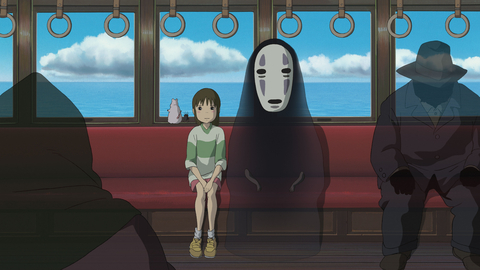 A scene from an animated film depicting a train interior with a girl seated, surrounded by shadowy figures and ocean views outside.