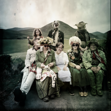 The Kotting Family all sat together in varying stages of fancy dress.