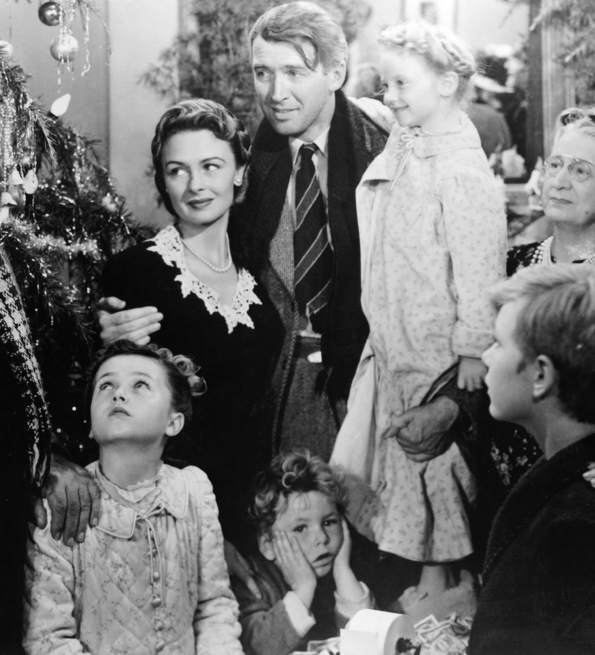 A black-and-white family gathering around a decorated Christmas tree, celebrating joyfully amidst holiday decorations and gifts.