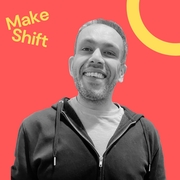 Tony is a smiling man in a black hoodie on a red background with the words "Make Shift" in yellow at the top left, conveying a cheerful tone.