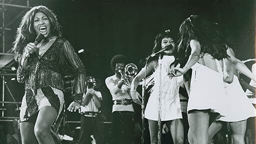 A dynamic stage scene featuring performers in vibrant costumes during the historic Soul to Soul concert in Ghana.