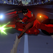 Anime scene of a character in a red jacket performing a sharp turn on a futuristic red motorcycle on a city street at night.