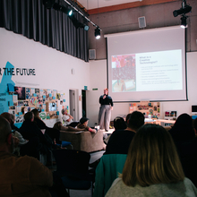 An image of Coral Manton giving a talk on the role of the Creative Technologist to a large audience. 