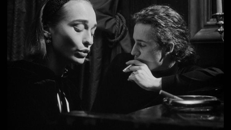 Black-and-white noir portrait of a woman and man sitting together in a dimly lit room, cinematic shadows, cigarette smoke, vintage atmosphere, and dramatic film-style photography.