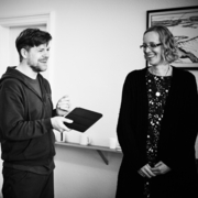 A black and white photo of three people standing in a room.
