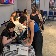 An group of people in a craft and chat session.