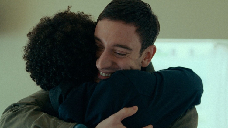 A man hugging a woman.