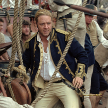 A still from Master and Commander: The Far Side of the World of a man standing on a boat surrounded by people