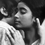 A black and white photo of two young people in an embrace.