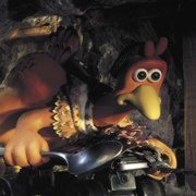 Claymation chicken character wearing a dress and hat, holding a spoon, crawling on a rope in a dimly lit cave with a wooden ladder.