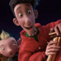 Animated scene of two characters, one human and one elf-like, excitedly looking over the edge of a red sleigh at night.