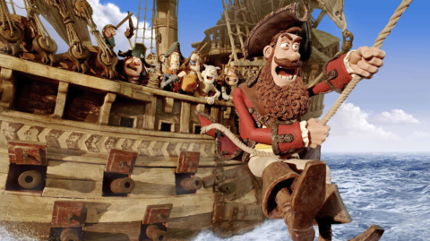 Animated pirate crew aboard a wooden ship, with a bearded pirate swinging on a rope over ocean waves under a blue sky with clouds.