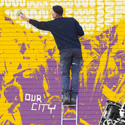 A man on a ladder painting