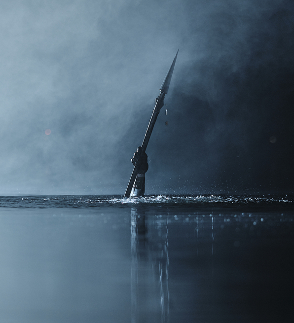 Hand holding a spear emerging from dark, misty water with droplets falling and reflections on the surface.