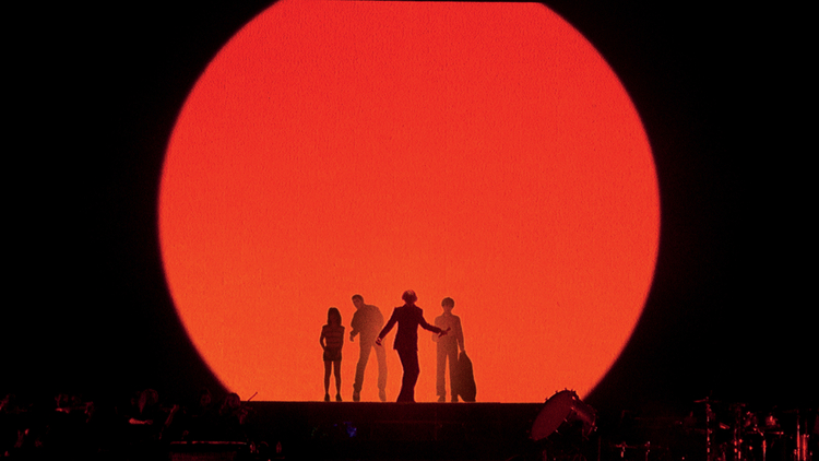 Shadows of Pulp standing in front of a red circle 