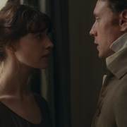A still of a man and a woman looking at each other