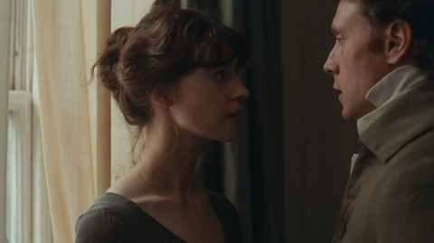 A still of a man and a woman looking at each other