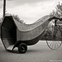 An image of Dominique Vyborna pushing a comically oversized horn on wheels.