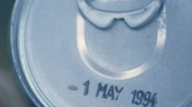 Close-up of a can featuring and the stamped date “1 MAY 1994.”